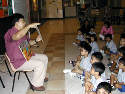 Don Soh telling gospel stories to an attentive audience.