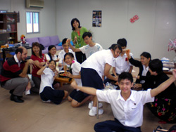 Christian fellowship during a Chinese New Year party. In the background is Ms Jaime Hang (in a green blouse)