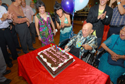 Mr Goh cutting the enormous chocolate cake.