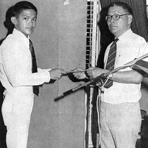 Mr Lau presenting Letter of Appointment to Head Assistant Prefect, Khoo Teng Cheong in 1978.