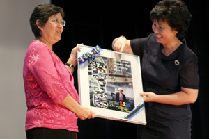 Mrs Lim Han Soon receiving her collage.