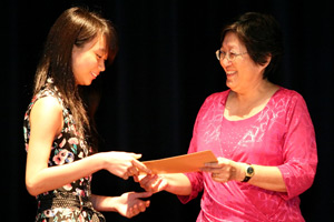 Prize Winner receiving award from Mrs Lim Han Soon